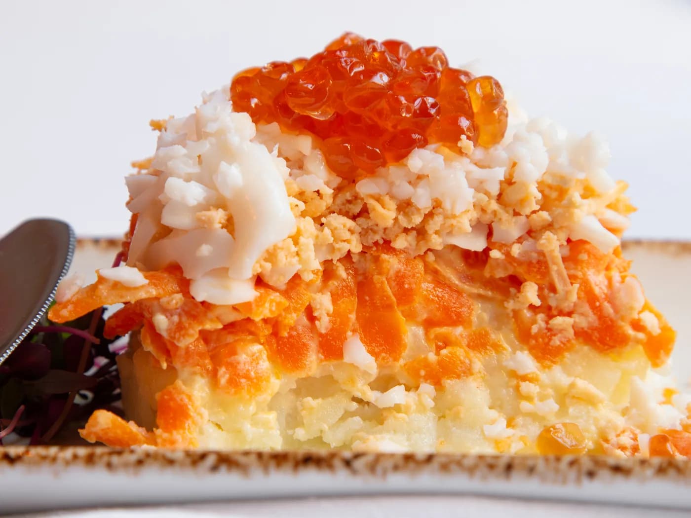 Open tart topped with salmon roe and sour cream