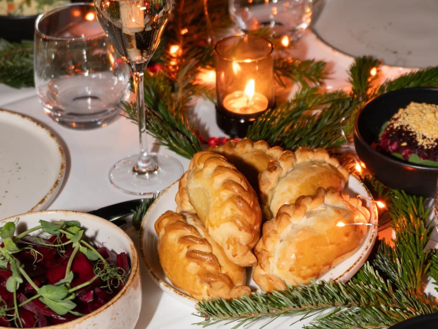 New Year's table with tangerines, pirozhki and candles