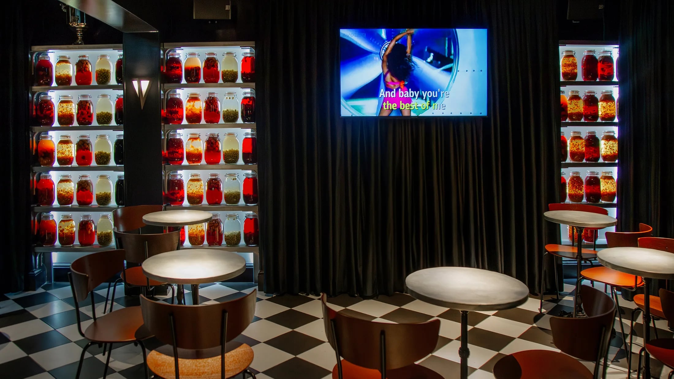 ZIMA karaoke bar downstairs with booths and screens