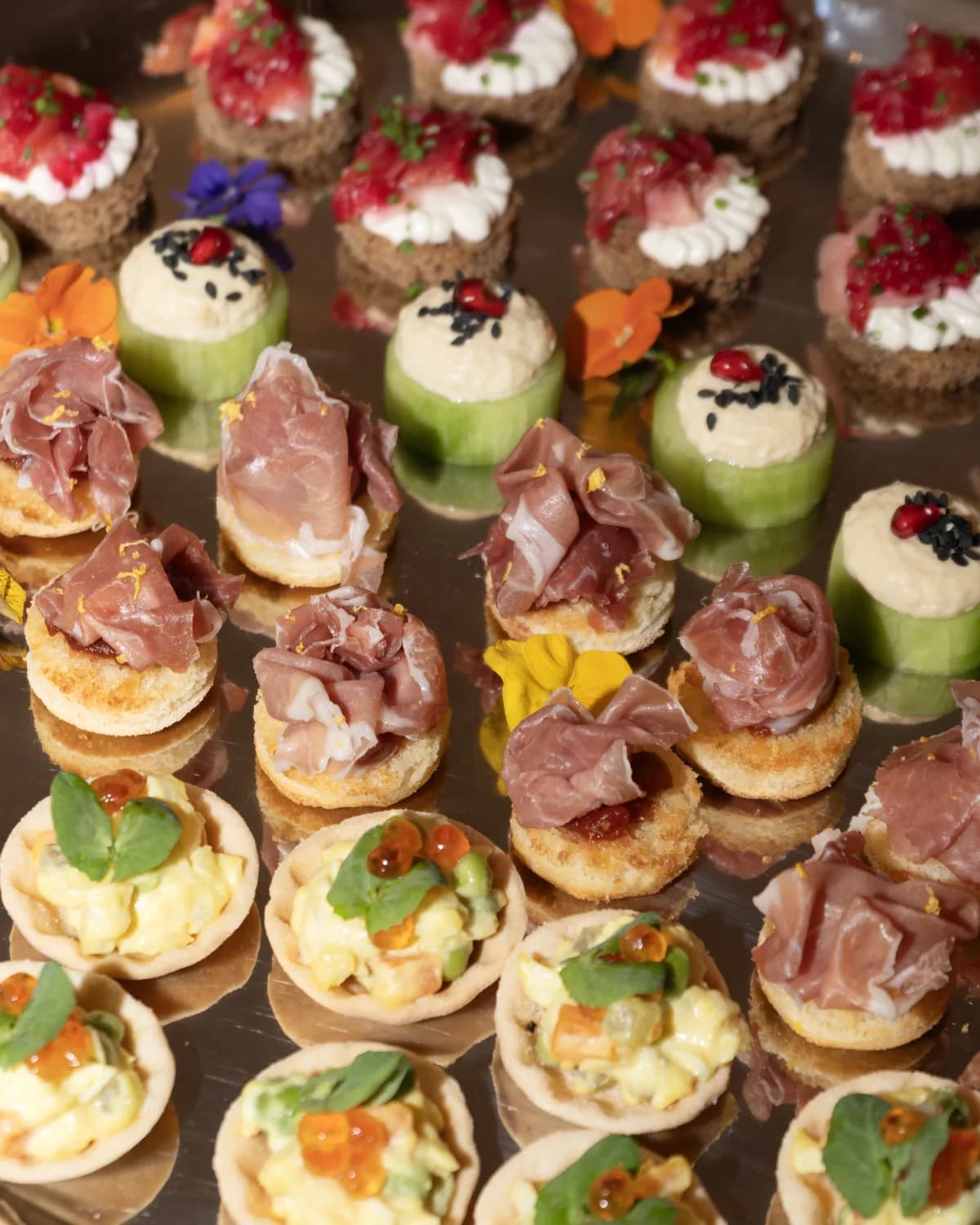 Tray of ZIMA canapés with cured meats and cucumber