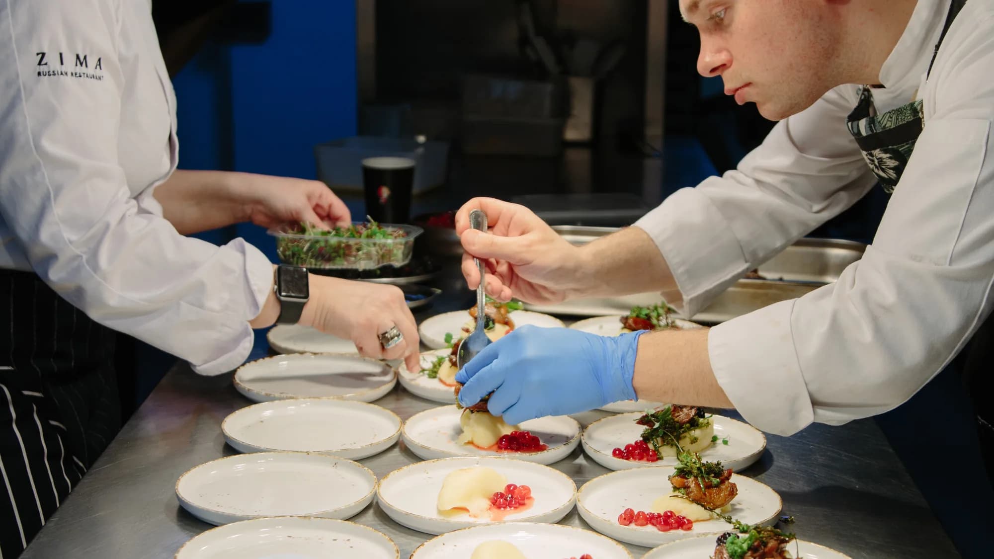 ZIMA kitchen team plating a catering order
