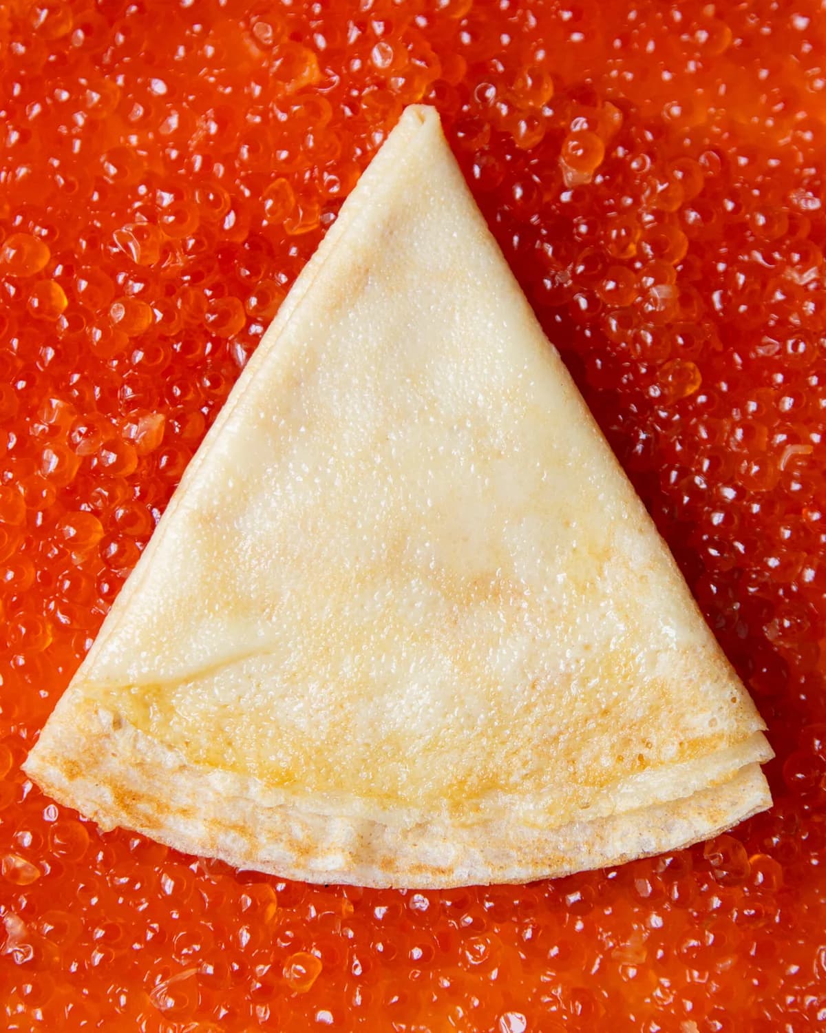 Folded blin on a bed of red caviar