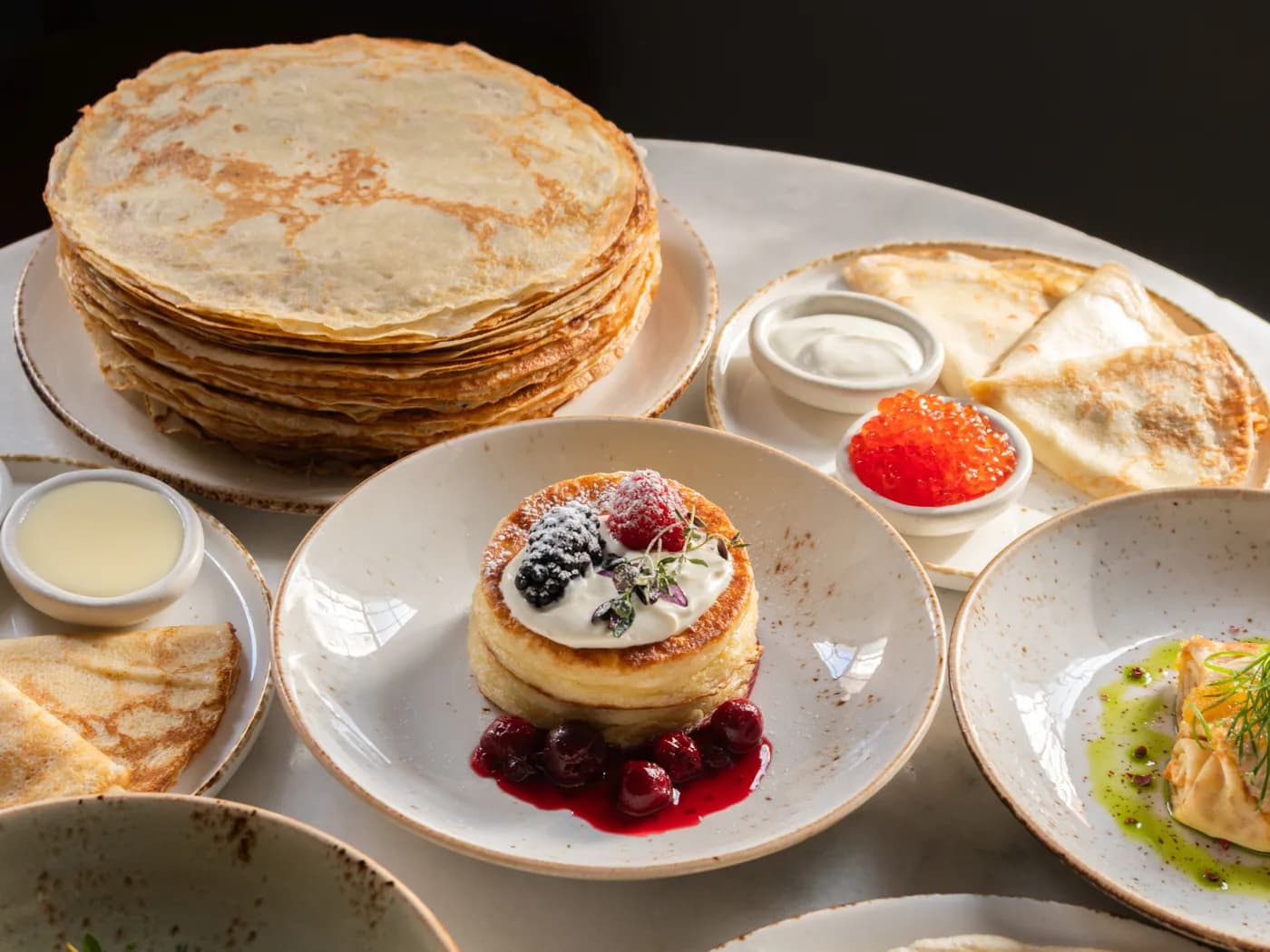 Maslenitsa table laid with blini, caviar and tea