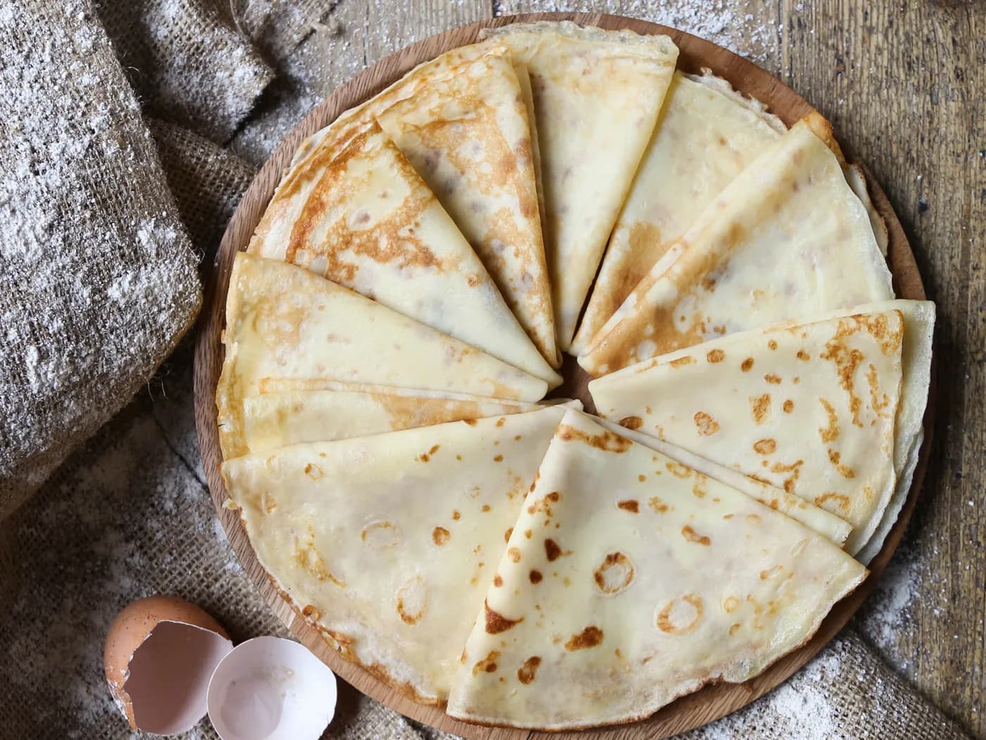 A tall stack of blini cut into wedges