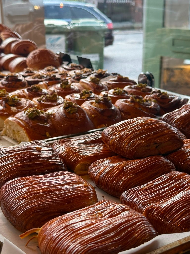 Fresh laminated pastries and pistachio buns